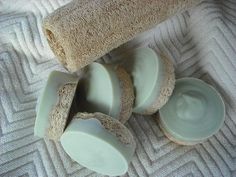 four pieces of soap sitting next to each other on top of a white towel covered floor