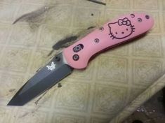 a hello kitty knife is laying on the table