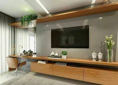 a large flat screen tv mounted to the side of a wall in a living room