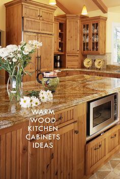 a kitchen with wooden cabinets and granite counter tops, an oven in the center is surrounded by white flowers