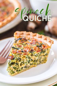 a slice of spinach quiche on a plate with a fork next to it