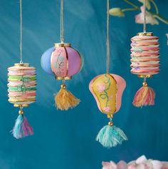 four different colored paper lanterns hanging from strings