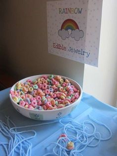 a bowl filled with cereal sitting on top of a blue table cloth next to a rainbow sign