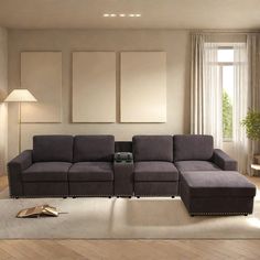 a living room with a couch, table and lamp on the floor in front of it