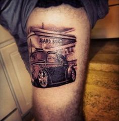 a man's leg with an old car tattoo on it