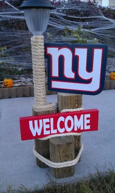 a welcome sign is attached to a pole