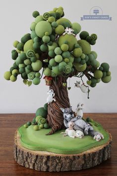 a small tree with animals around it