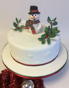 a christmas cake with a snowman on top