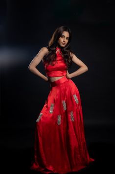 Adding a touch of royal elegance and grace to weddings and festivities, this stunning scarlet-red lehenga is a must-have! The cupro satin fabric is soft and lightweight, making it perfect for twirling around the dance floor. The intricate hand-embroidered mirror work adds a unique sparkle to your look.Details Neckline: Halter neck Material: Cupro satin Lining: Cotton-polyester Made in India Material This outfit is made with cupro satin; the fabric is made from cotton linter wasteIt is a sustainable alternative to polyester Festive Red Dola Silk Gown, Silk Lehenga With Mirror Work For Party, Silk Sharara For Reception Party Wear, Silk Anarkali Traditional Evening Wear, Elegant Red Lehenga With Unstitched Blouse, Evening Lehenga With Zari Work In Raw Silk, Red Traditional Wear For Evening, Red Traditional Evening Wear, Silk Lehenga With Resham Embroidery For Party Wear