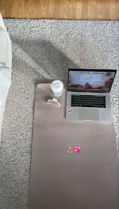 an open laptop computer sitting on top of a carpeted floor