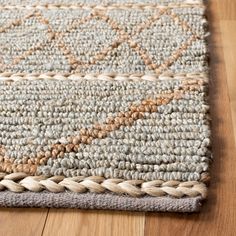 an area rug with braided edges on a wooden floor