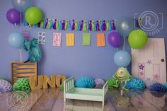 a room decorated with balloons, streamers and decorations