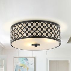 a black and white circular light fixture in a room