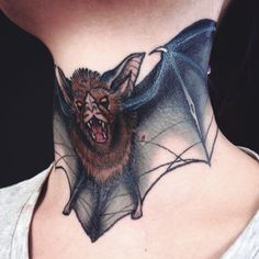 a woman with a bat tattoo on her neck