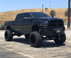 a large black truck parked in a parking lot