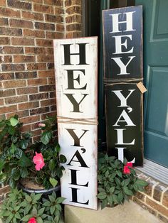 a sign that says hey yeah yall on it next to a potted plant