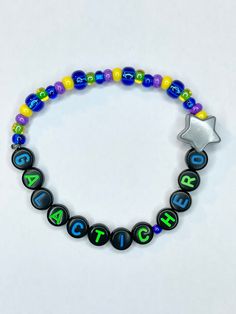 Have you ever gotten the perfect score of 999,999? Are you a natural at defeating the evil emperor? If so this bracelet is perfect to showcase your skills! Galactic Hero beaded stretch bracelet with a large Star bead charm is definitely better than a sticker!  Bracelets are available in a variety of lengths.  Pick your custom length from the drop down menu below.  All our bracelets are made with quality in mind.  With that being said, all bracelets should be treated with care while putting on, w Hero Bracelet, Disney Friendship, Disney Bracelets, Evil Emperor, The Perfect Score, Apple Watch Bands Fashion, Perfect Score, Space Ranger, Star Theme