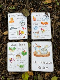 four cards with pictures of food items on them in the dirt and leaves around them