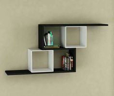 two black and white shelves with books on each shelf next to a bookcase against the wall