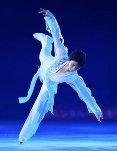 a woman in white is performing on the ice