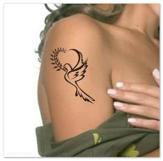 a woman's arm with a tattoo design on the back of her shoulder,