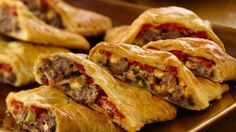 some meat and cheese pastries on a table