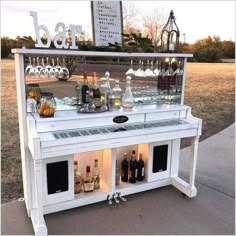 an outdoor bar with bottles and glasses on it