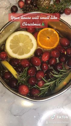 a bowl filled with cherries and lemon slices