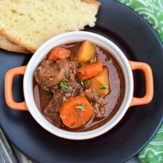 a bowl of stew with bread on the side