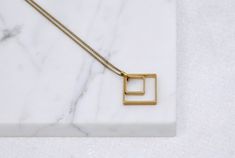 Two Squares Pendant | Minimal Geometric Jewelry | Everyday Necklace Minimalist Rectangular Brass Jewelry, Minimalist Brass Square Pendant Jewelry, Minimalist Brass Necklace With Square Pendant, Raw Peridot, Geometric Pendant Necklace, Shrink Film, Round Bead Necklace, Chevron Necklace, Tibetan Jewelry