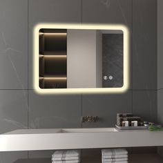 a bathroom with a sink, mirror and towels on the shelf in front of it