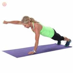 a woman doing push ups on a purple mat