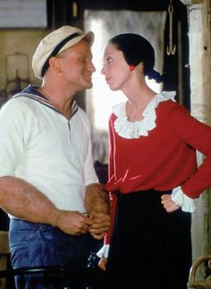 an older man and young woman standing next to each other