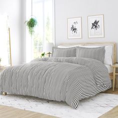 a bed with black and white striped comforter