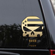 an american flag skull sticker on the back of a car with trees in the background