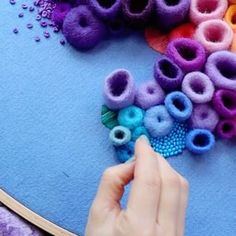 someone is making something out of felt and beads