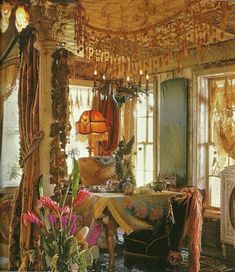 the room is decorated in an old fashion style and has many flowers on the table