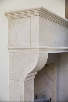 a fire place with a clock on the top and a fireplace mantel above it