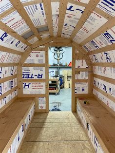 the inside of a small building with wooden beams and signs on it's walls