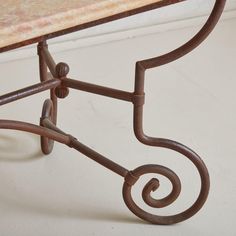 an iron bench with a marble top