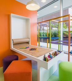 an orange and white room with various colored stools in front of the window that overlooks a swimming pool