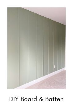 an empty room with some green walls and white trim on the wall is shown in this image