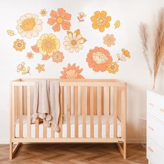 a baby's crib with flowers painted on the wall