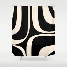 a black and white shower curtain with an abstract design on the front, featuring wavy lines