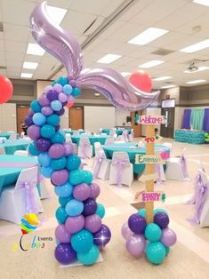 balloons are arranged in the shape of mermaid tails and tailes at a birthday party