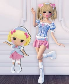 two dolls are standing next to each other