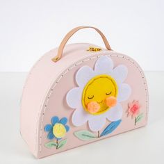 a pink purse with a yellow flower on the front and white flowers on the back