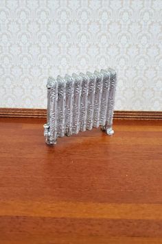 a radiator sitting on top of a wooden floor in front of a wall