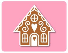 a gingerbread house with a heart on the front and side, cut out from paper