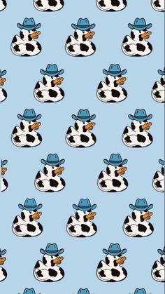 a cow with a cowboy hat on it's head is sitting in the middle of a blue background